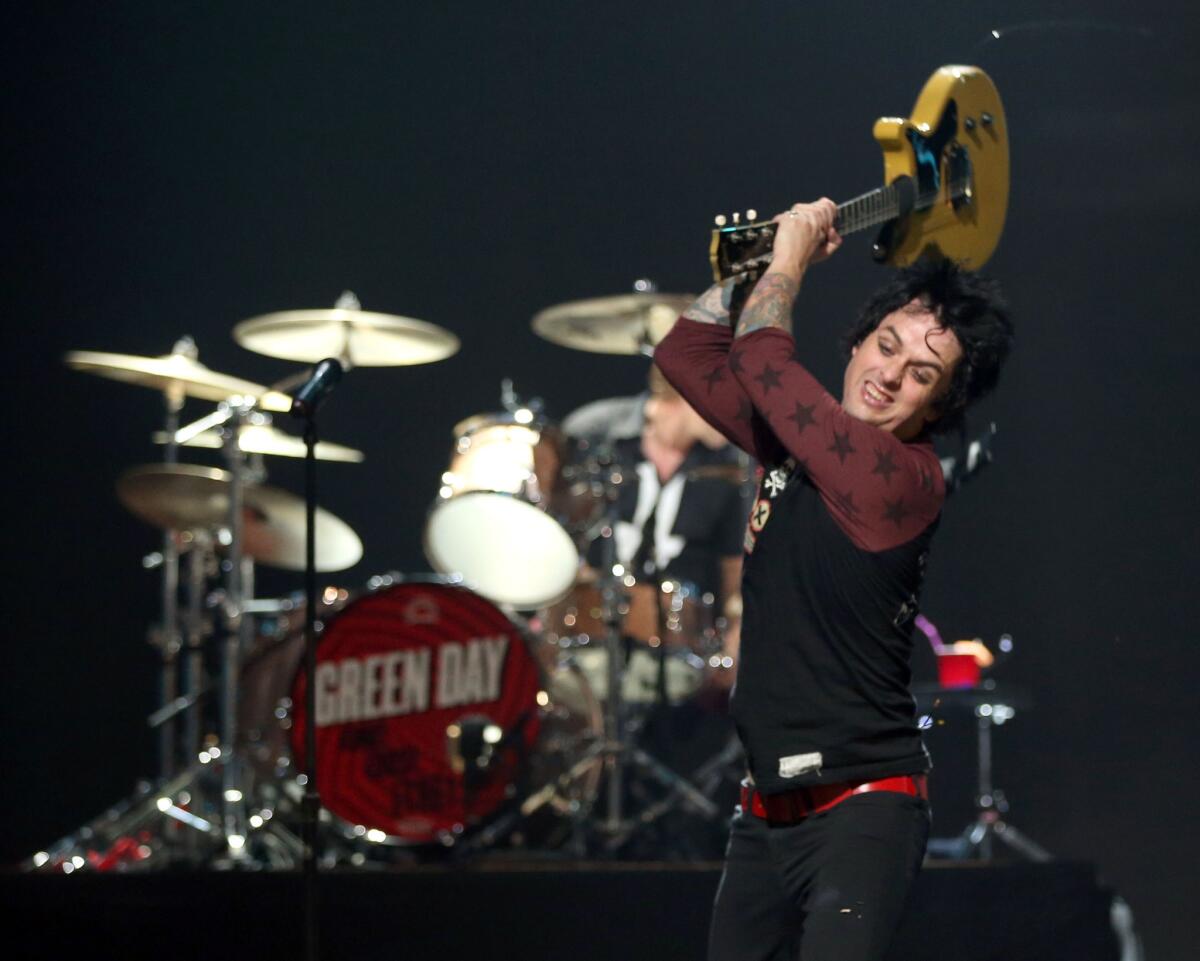 Green Day's Billie Joe Armstrong smashes his guitar at the iHeartRadio Festival in Las Vegas.