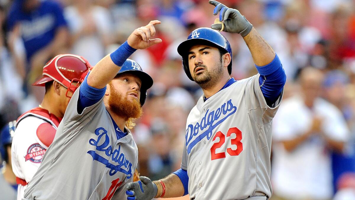 Third baseman Justin Turner, left, and first baseman Adrian Gonzalez haven't had much to celebrate recently, other than the Dodgers continuing their winning ways as they have slumped.