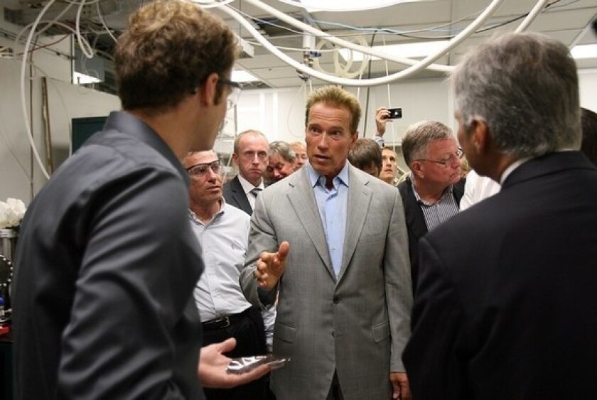 Former Gov. Arnold Schwarzenegger tours a solar energy company in Los Angeles in September.