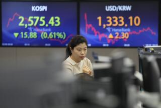 A currency trader watches monitors near the screens showing the Korea Composite Stock Price Index (KOSPI), left, and the foreign exchange rate between U.S. dollar and South Korean won at the foreign exchange dealing room of the KEB Hana Bank headquarters in Seoul, South Korea, Tuesday, Feb. 6, 2024. Shares are mixed in Asia, where Chinese markets advanced after a government investment fund said it would step up stock purchases. (AP Photo/Ahn Young-joon)
