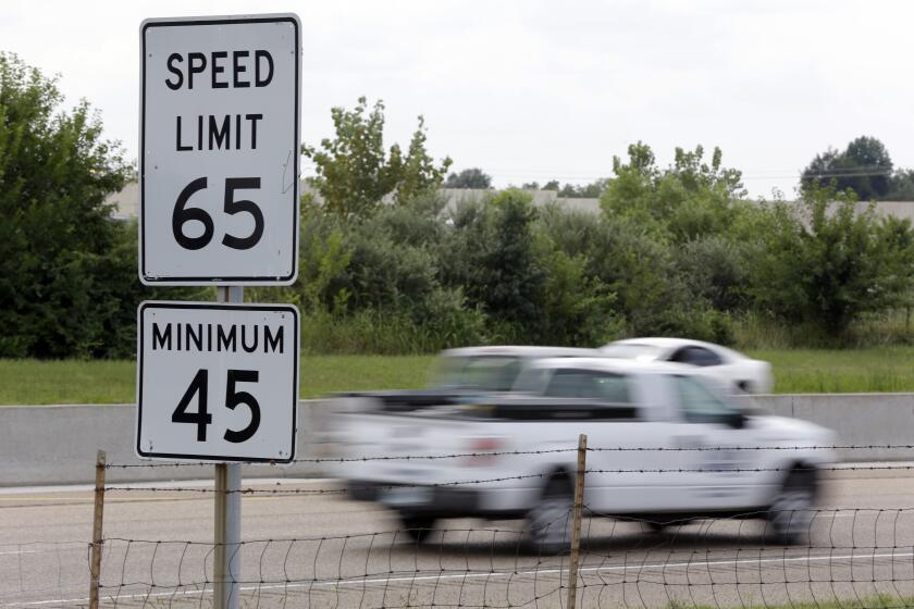 ADVANCE FOR USE MONDAY, DEC. 23 AND THEREAFTER - FILE - In this Aug. 16, 2013 file photo, vehicles pass a 65 mph speed limit sign along Interstate 64 in O'Fallon, Ill. Illinois Gov. Pat Quinn signed into a law in August, a bill allowing motorists to drive 70 mph on rural interstates. It's one of the many news law that goes into effect in January 2014. (AP Photo/Jeff Roberson, File)