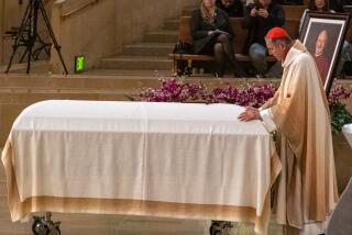 Los Angeles, CA - March 02: Cardinal Roger Mahony, Archbishop Emeritus prays over the casket during the Vigil Mass for Catholic Auxiliary Bishop David Gerard O'Connell at the Cathedral of Our Lady of the Angels on Thursday, March 2, 2023, in Los Angeles, CA. O'Connell, was gunned down on February 18th at his home in Hacienda Heights. (Francine Orr / Los Angeles Times)