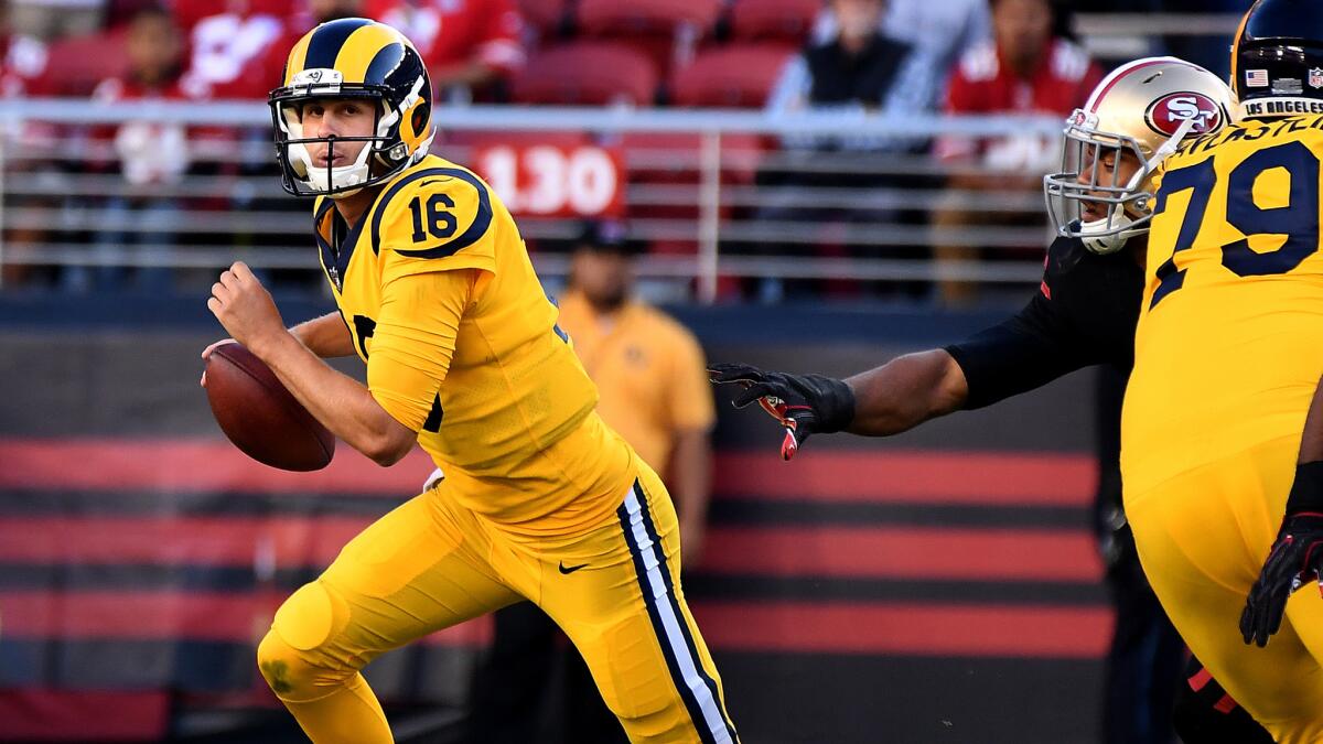 Rams quarterback Jared Goff scrambles away from pressure during the second quarter.