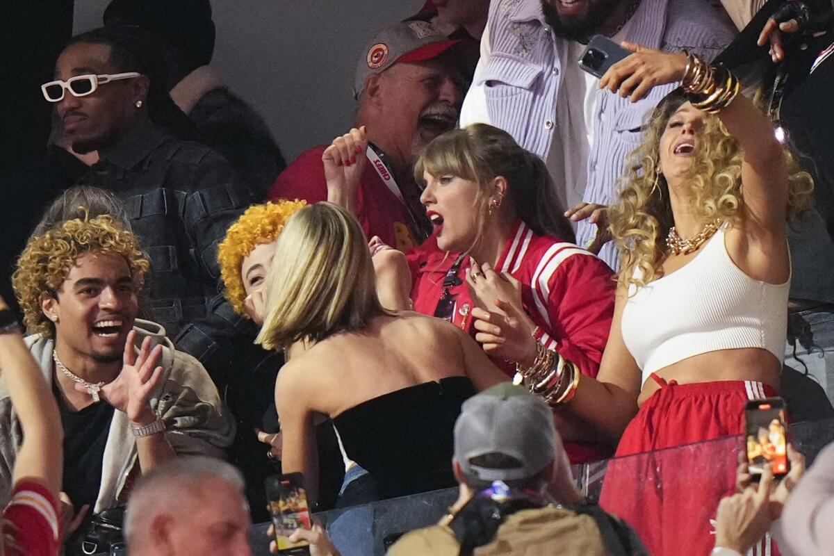 Taylor Swift (center) celebrates with friends at Super Bowl LVIII.