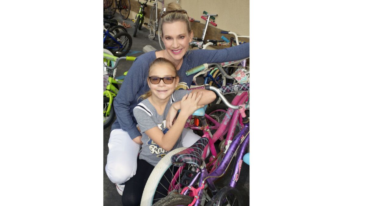Lisa Matzner Eaton and her daughter Reese, made a donation of two bikes at last week's event that benefits Bike Angels and, ultimately, local kids who would otherwise not be able to afford bikes.