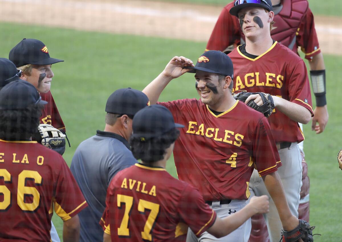 Estancia pitcher Trevor Scott (4) is congratulated by teammates during Monday's game.