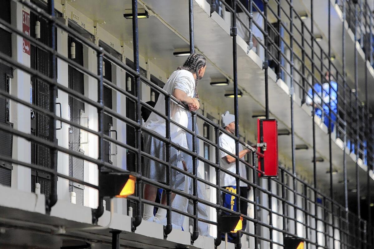 San Quentin inmates walk around a cellblock. Forty-six percent disapproved of his record on prisons, compared with 30% who approved.