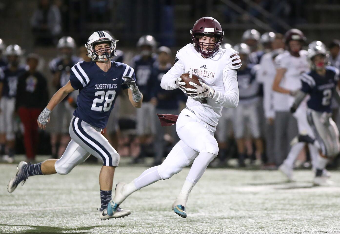 Sean Nolan pulls in a pass on the run and takes it to the end zone in Laguna Beach High's CIF Southern Section Division 12 quarterfinal playoff game against Northwood at Irvine High on Friday.
