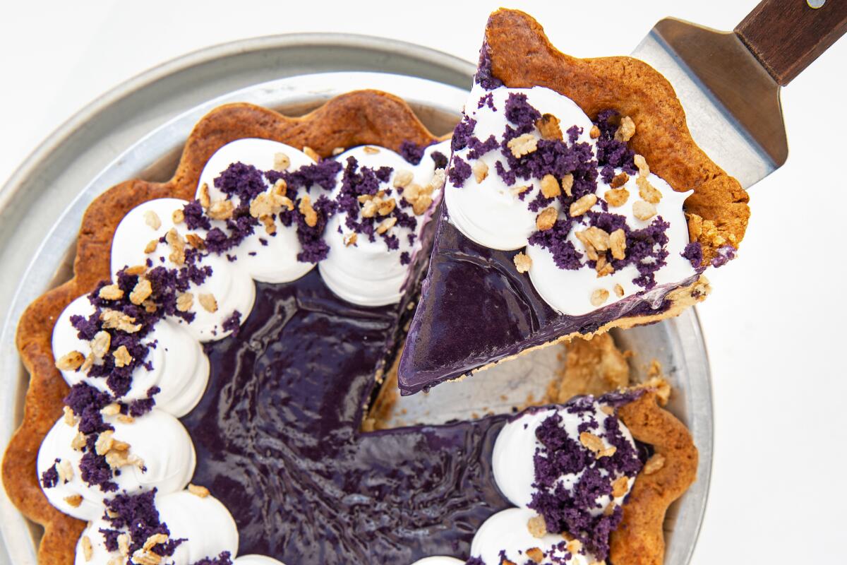 A slice of Ube blondie pie is displayed above the rest of the pie.