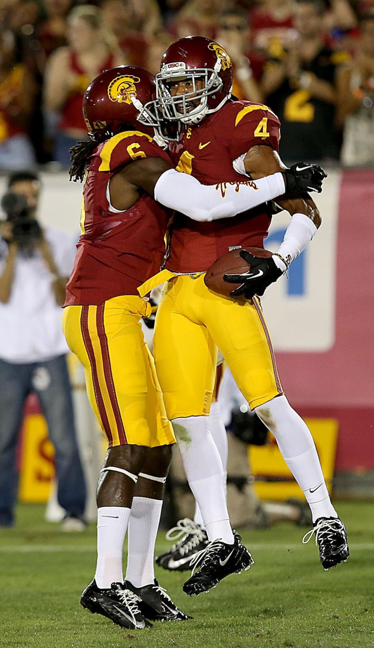 USC cornerback Torin Harris, right, is congratulated by teammate Josh Shaw after intercepting a pass against Washington State on Saturday. The Trojans will be looking for another strong defensive effort against Boston College this week.