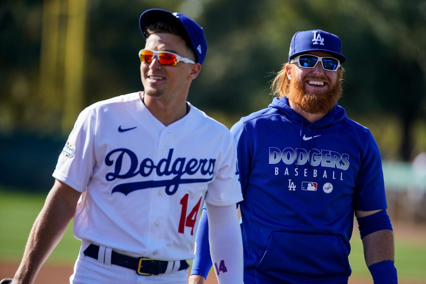 The Dodgers' Kiké Hernández (14) and Justin Turner walk off field after a practice at Camelback Ranch