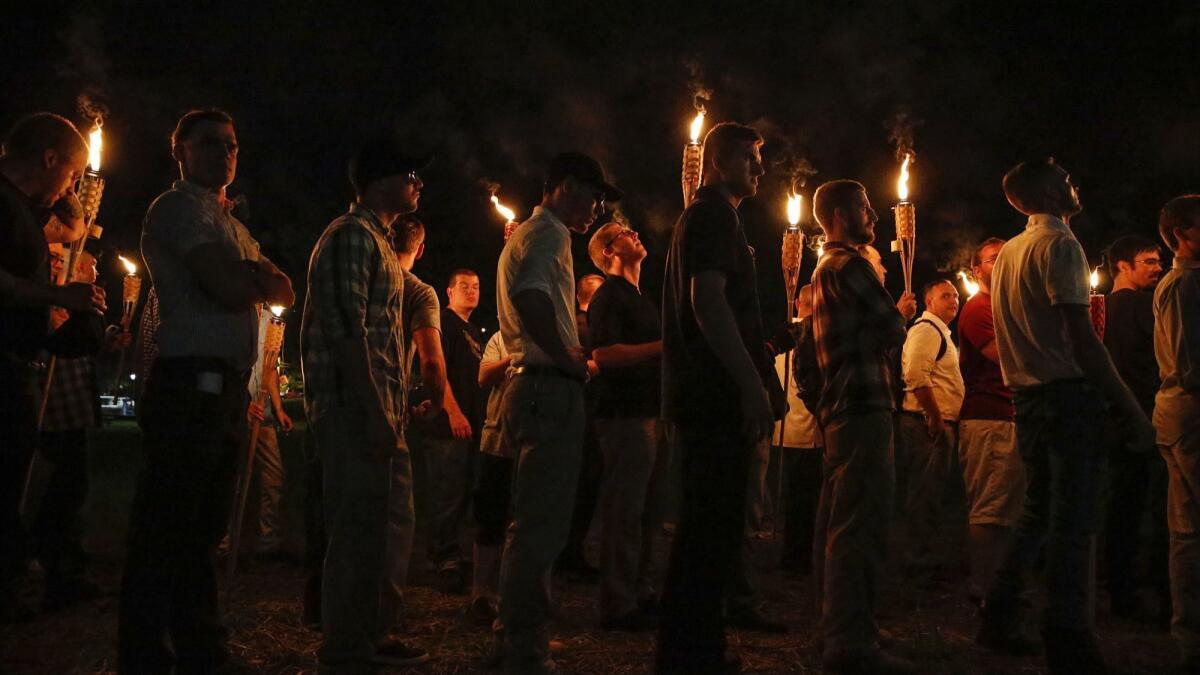 White nationalist groups march with torches through the University of Virginia campus in Charlottesville in 2017.