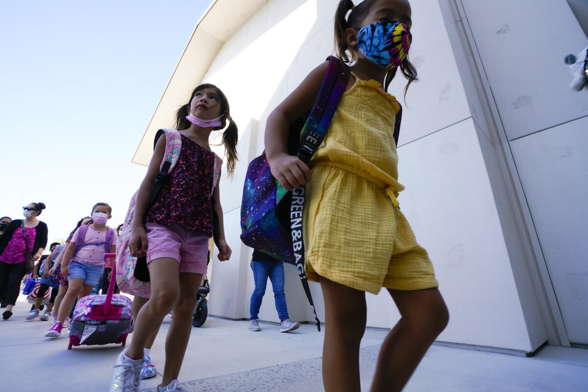 Children head into Enrique S. Camarena Elementary School in Chula Vista in July 