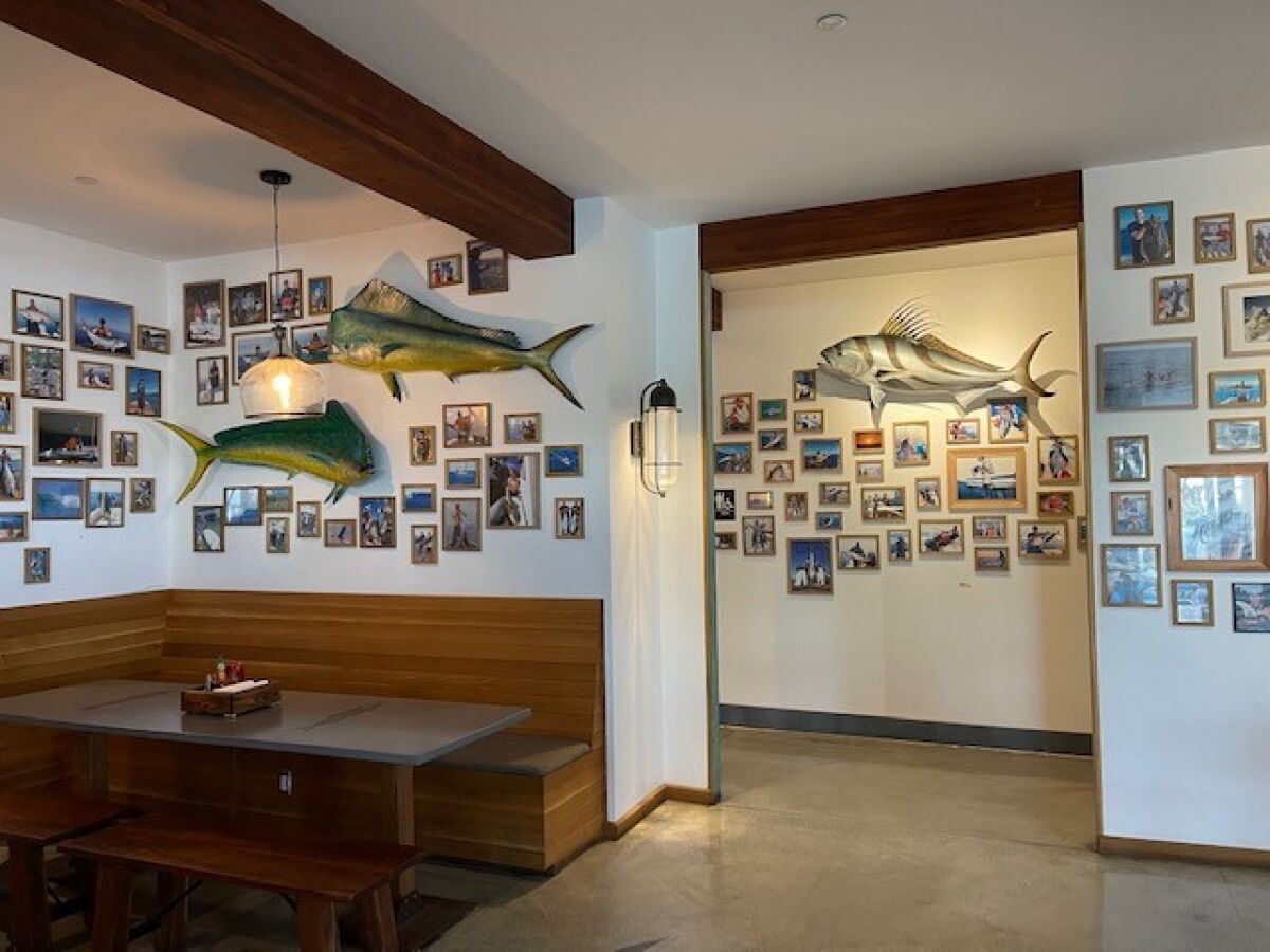 The interior decor at Blue Water Seafood includes mahi mahi (left) and rooster fish (right).