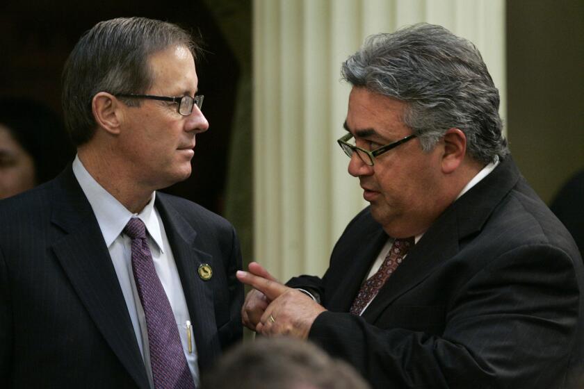 State Sen. Tom Berryhill (R-Modesto), left, pictured during a 2007 floor conversation with state Sen. Ron Calderon, D-Montebello.