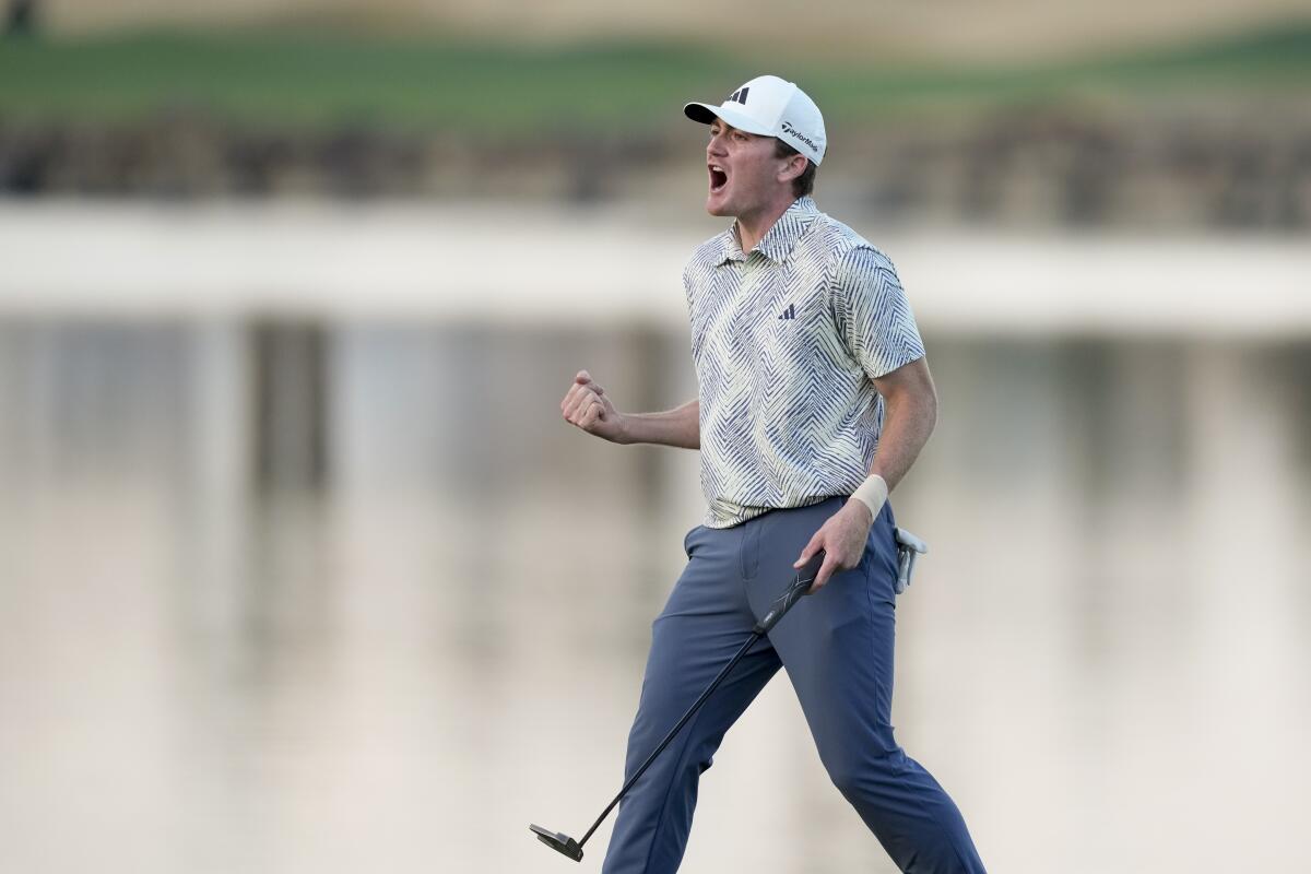 Nick Dunlap celebrates after making a putt on the 18th hole to win the American Express golf tournament.