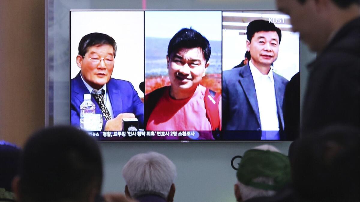 A television news broadcast displays a portrait of three Americans detained in North Korea: from left, Kim Dong Chul, Tony Kim and Kim Hak Song.