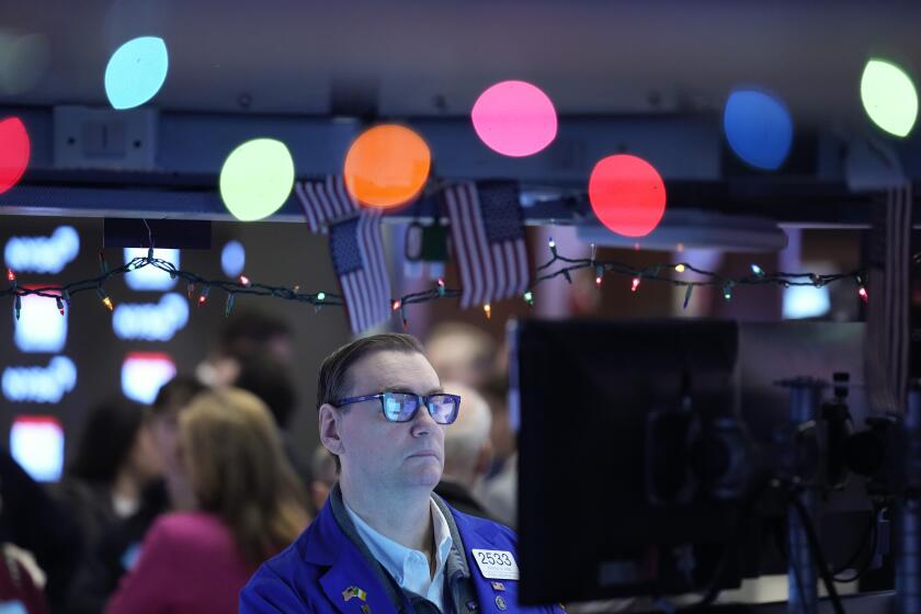 Traders work on the floor at the New York Stock Exchange in New York, Wednesday, Jan. 3, 2024. (AP Photo/Seth Wenig)