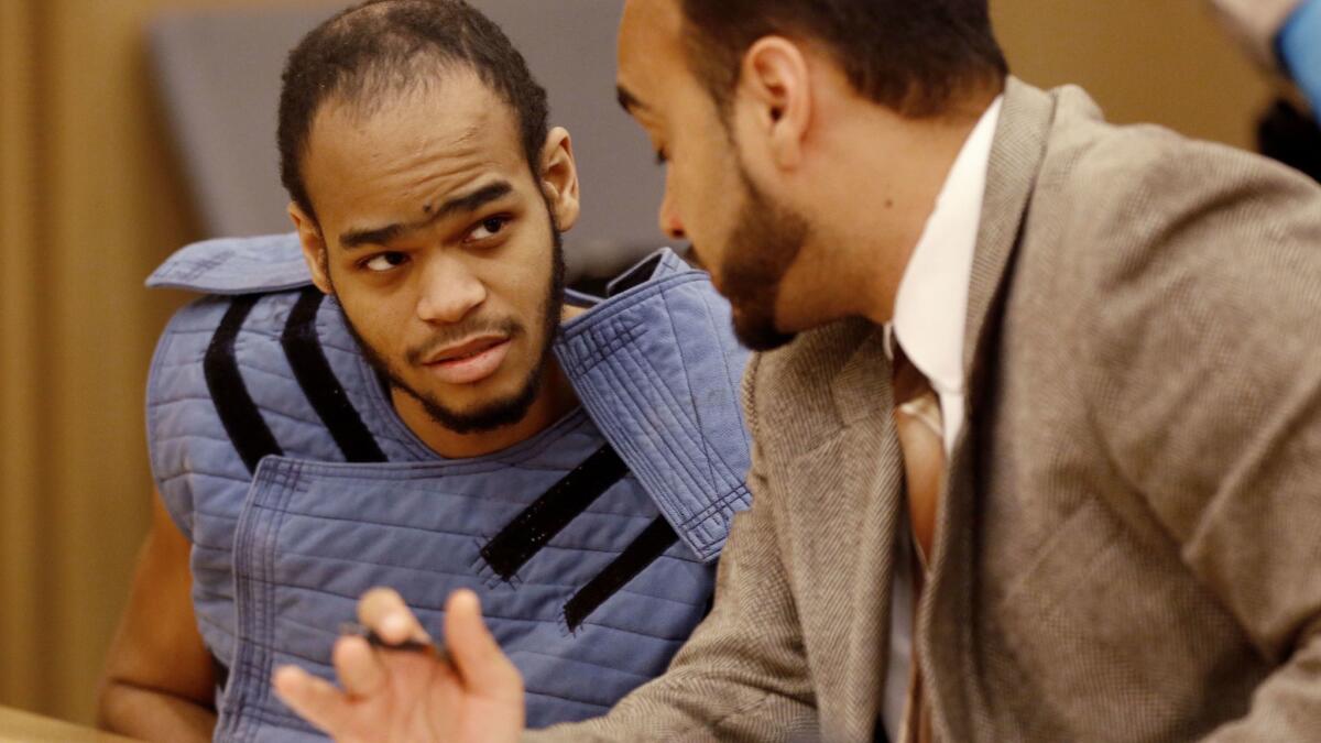 Brandon Colbert Jr., left, looks to his attorney, Jason O. Sias, for answers during a mental competency hearing in Long Beach.