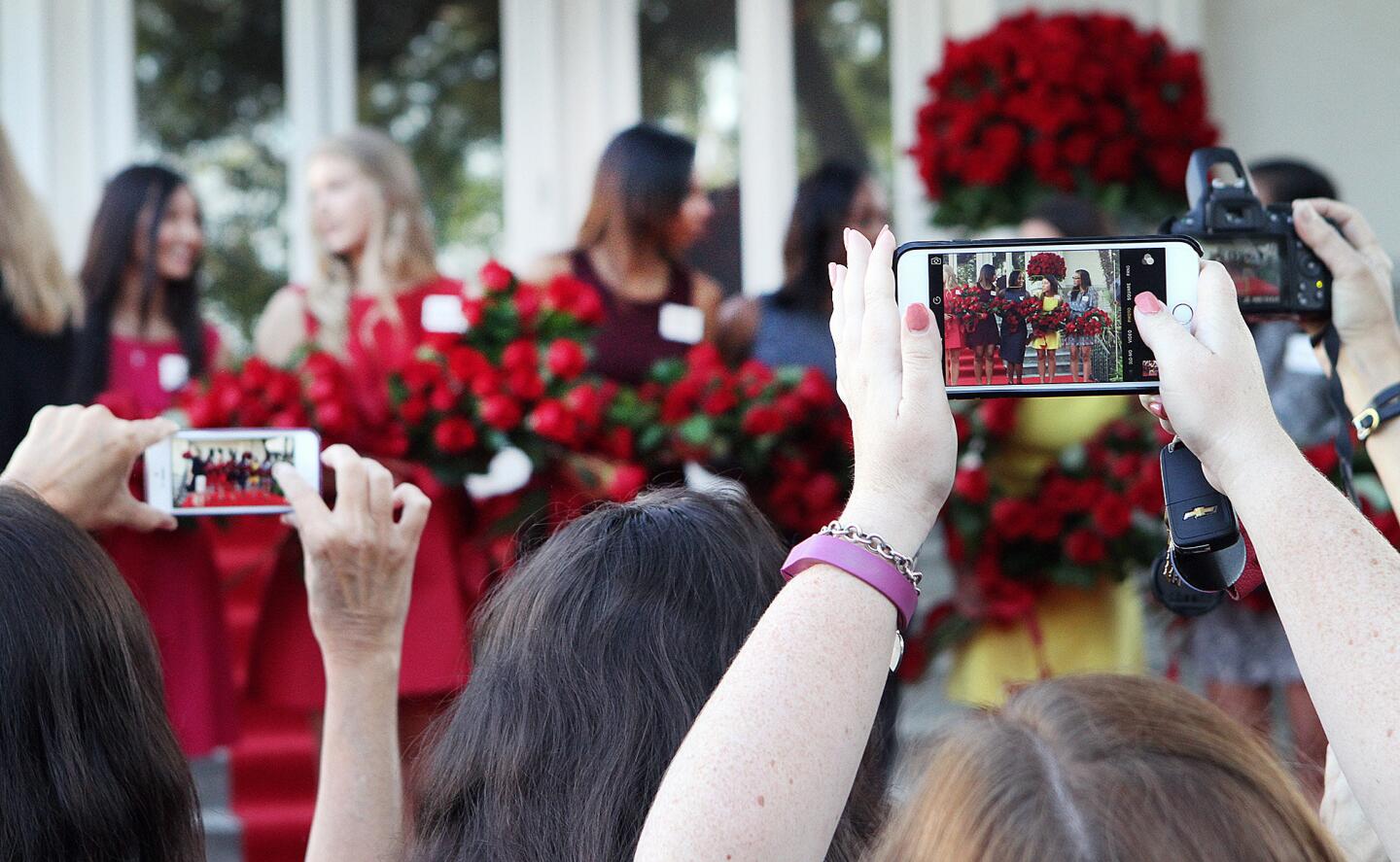 Photographers with cell phones and cameras held over their heads take pictures of the newly named 2016 Royal Court at the announcement of the 2016 Tournament of Roses Royal Court at the Tournament House in Pasadena on Monday, Oct. 5, 2015.