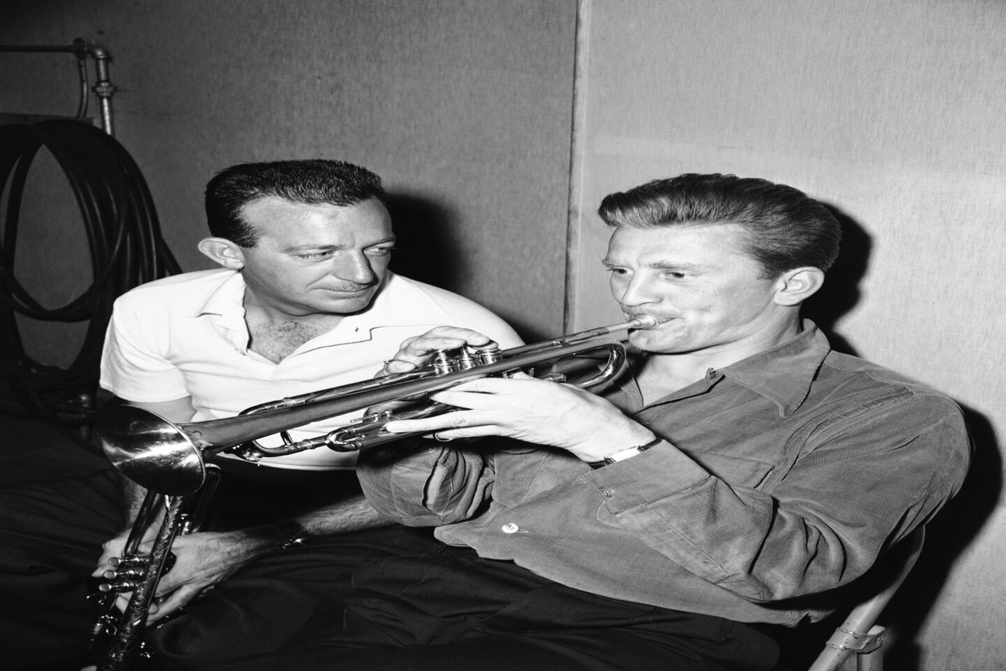 Famous trumpeter Harry James, left, shows Douglas how to play for the movie cameras. The toot-tutoring is in preparation for Douglas' role as a great trumpet player in the 1950 film "Young Man With a Horn."