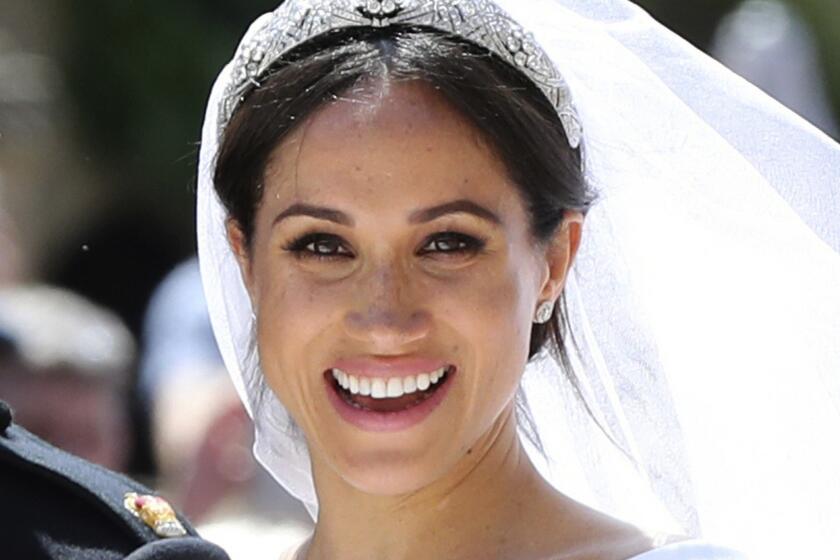 FILE - In this May 19, 2018, file photo, Meghan Markle leaves with Prince Harry after their wedding ceremony, at St. George's Chapel in Windsor Castle in Windsor, near London, England. With two blockbuster British royal weddings this year and an enduring fascination with the Brits, American brides craving a regal look with personal twists can find plenty of inspiration. (Gareth Fuller/pool photo via AP, File)