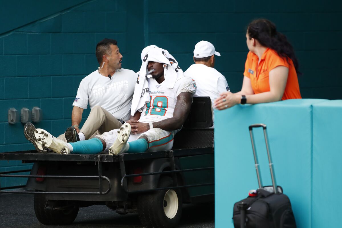 Miami Dolphins wide receiver Preston Williams (18) is taken away after an injury during the second half of an NFL football game against the New York Jets, Sunday, Nov. 3, 2019, in Miami Gardens, Fla. (AP Photo/Wilfredo Lee)