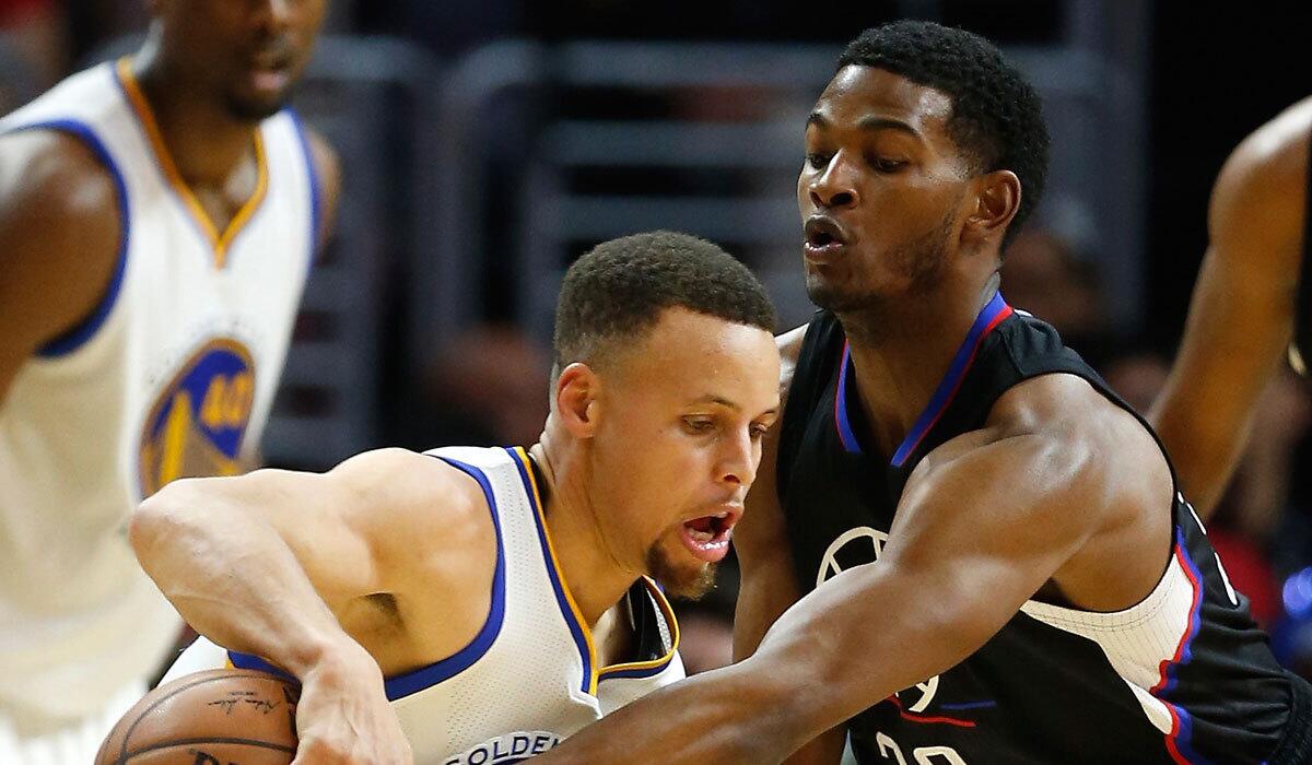 The Clippers' C.J. Wilcox, right, guards Golden State's Stephen Curry in February.