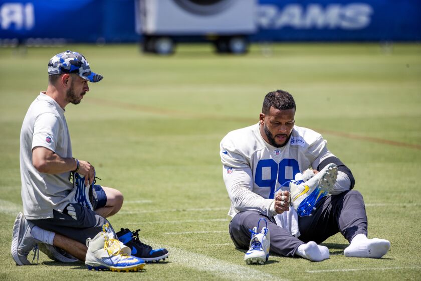 IRVNE, CA - JULY 24, 2022: Rams defensive tackle Aaron Donald changes his cleats during training camp at UC Irvine on July 24, 2022 in Irvine, California.(Gina Ferazzi / Los Angeles Times)
