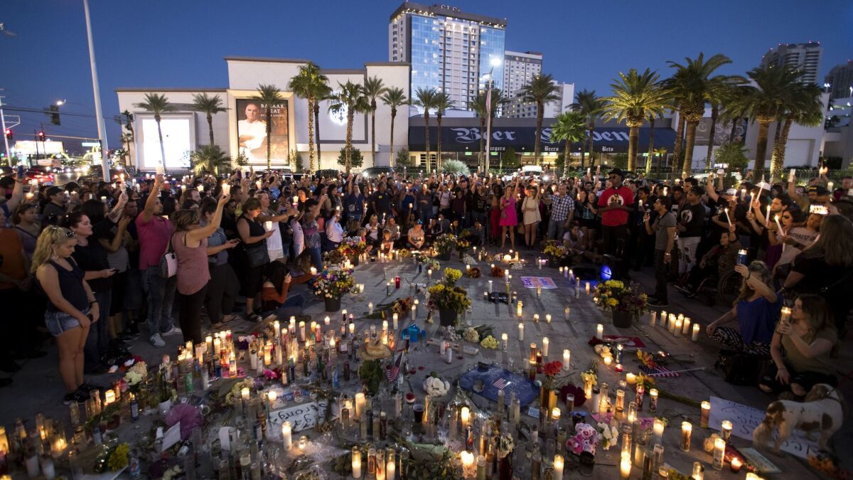 Mourners hold candles during a vigil a week after the Las Vegas mass shooting.