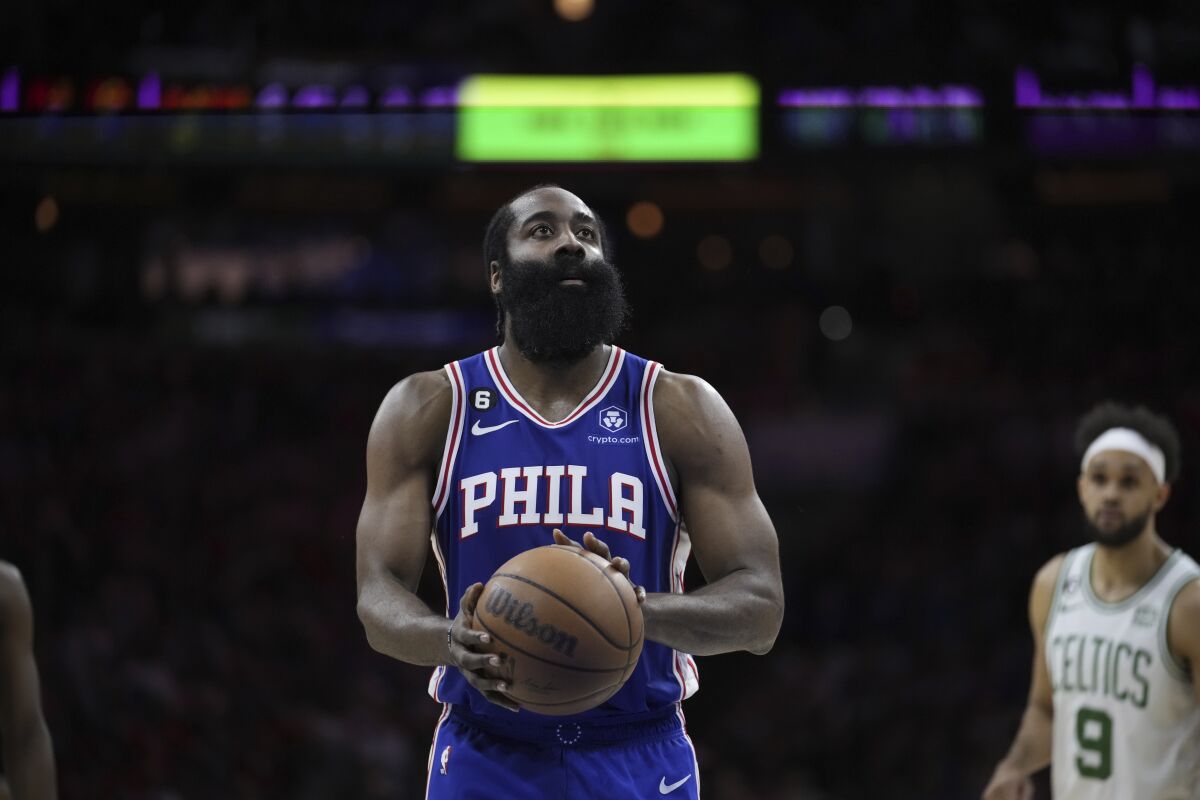 The Philadelphia 76ers' James Harden stands at free-throw line with the ball in his hands and looks to the basket.