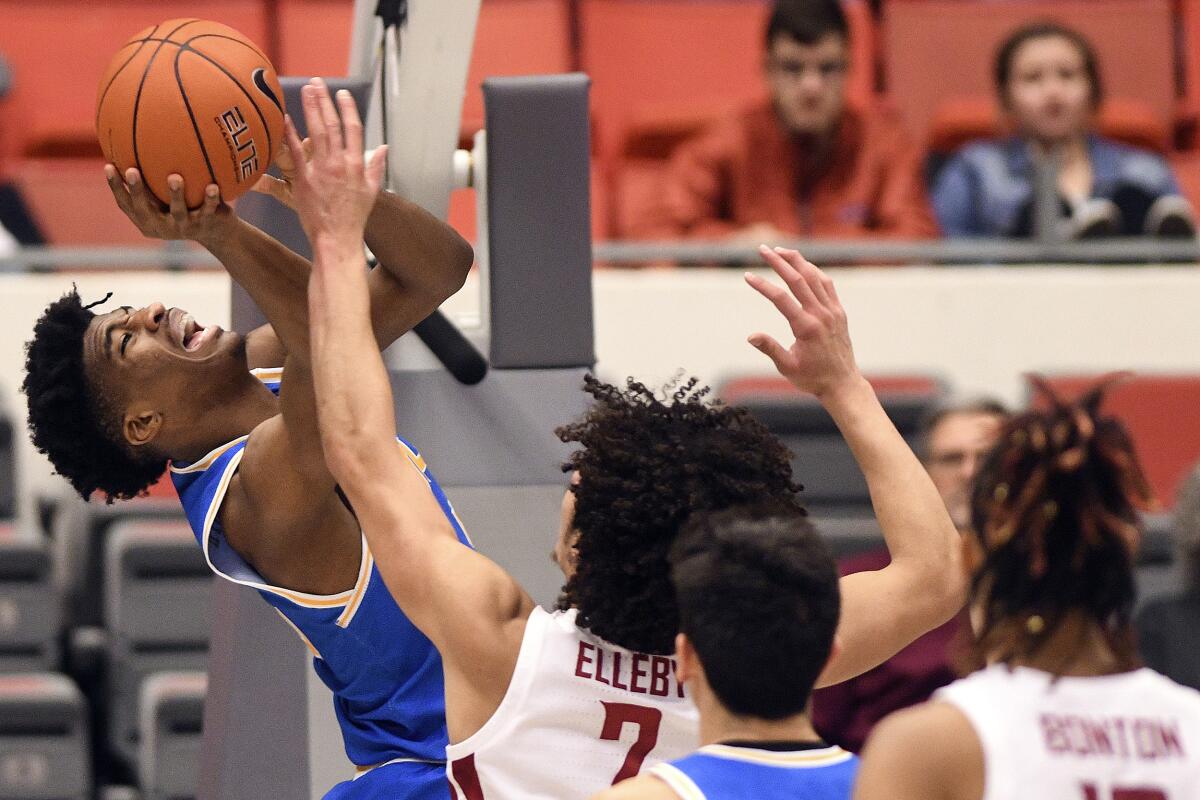 UCLA guard Chris Smith shoots over Washington State forward CJ Elleby during the first half of the Bruins' loss Saturday.