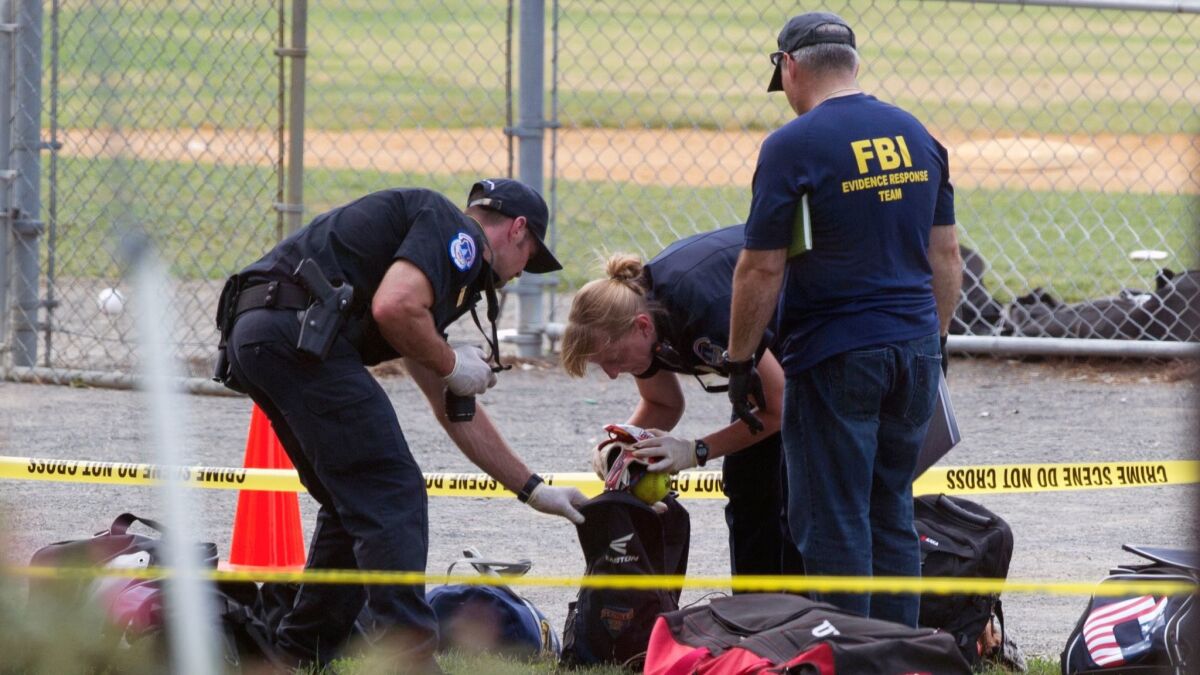 An FBI Evidence Response team inspects the contents of one of the many bags left at the scene of a shooting in Alexandria, VA. on June 14, involving House Majority Whip Steve Scalise of LA.