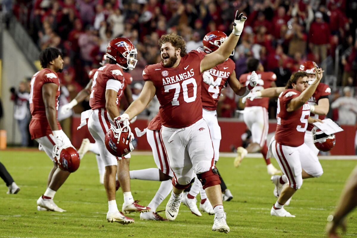 Arkansas offensive lineman Luke Jones (70) celebrates with his team after defeating Mississippi State during the second half of an NCAA college football game Saturday, Nov. 6, 2021, in Fayetteville, Ark. (AP Photo/Michael Woods)