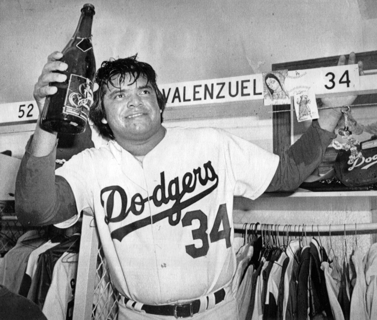 Fernando Valenzuela raises a bottle of Champagne in the Dodgers clubhouse.
