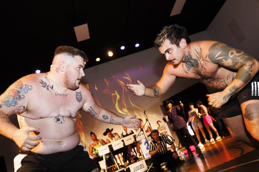 Silverlake, CA - September 21: Olin Schneider "Holden" (left) locks in with Paulo Diaz "Brawlo" (right) at the Trans Dudes of LA "T Boy Wrestling" event at the Hollywood Los Feliz Jewish Community Center on Saturday, Sept. 21, 2024 in Silverlake, CA. (Carlin Stiehl / For the Times)