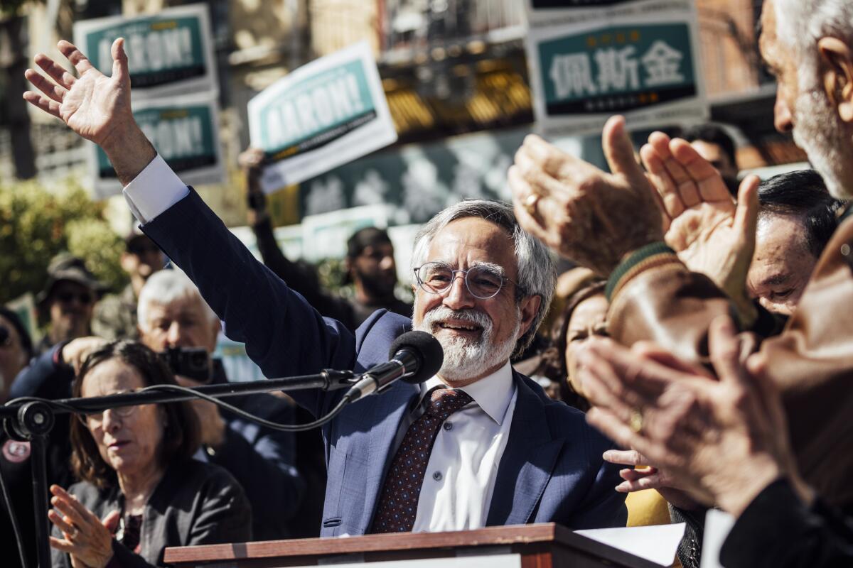 San Francisco Supervisor Aaron Peskin waves to a crowd of supporters at a mayoral campaign event.