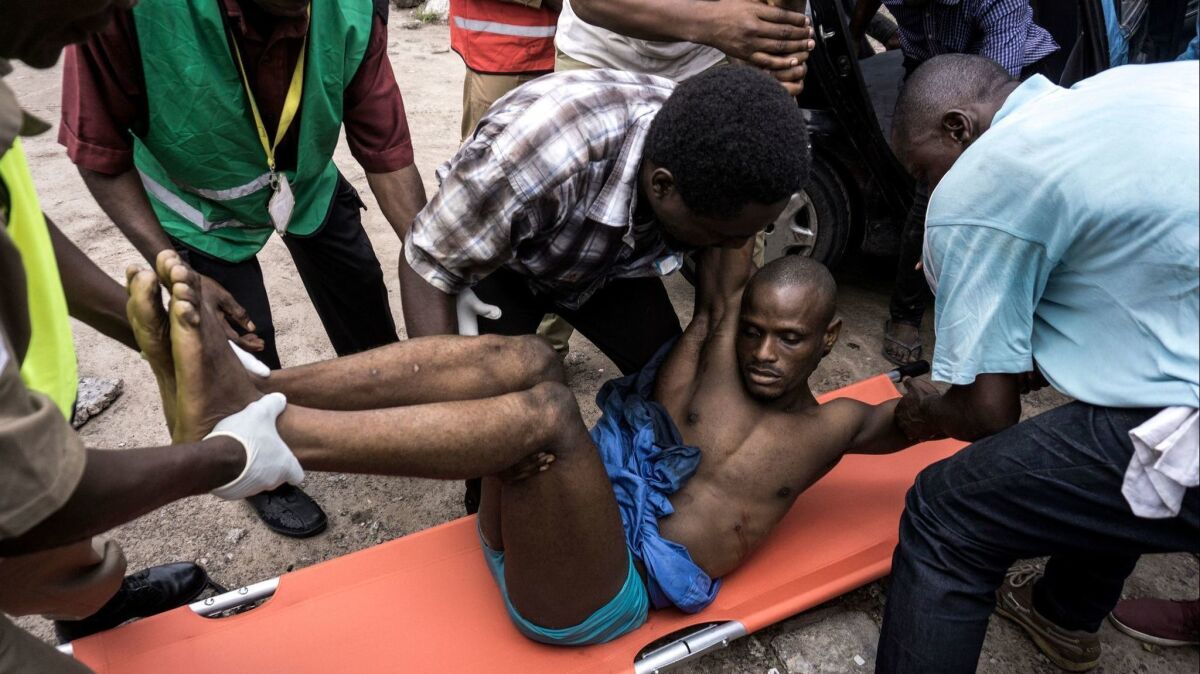 Moments after this photograph was taken, this Congolese man died after being shot by police during a protest called by the Catholic Church in Kinshasa on Feb. 25.