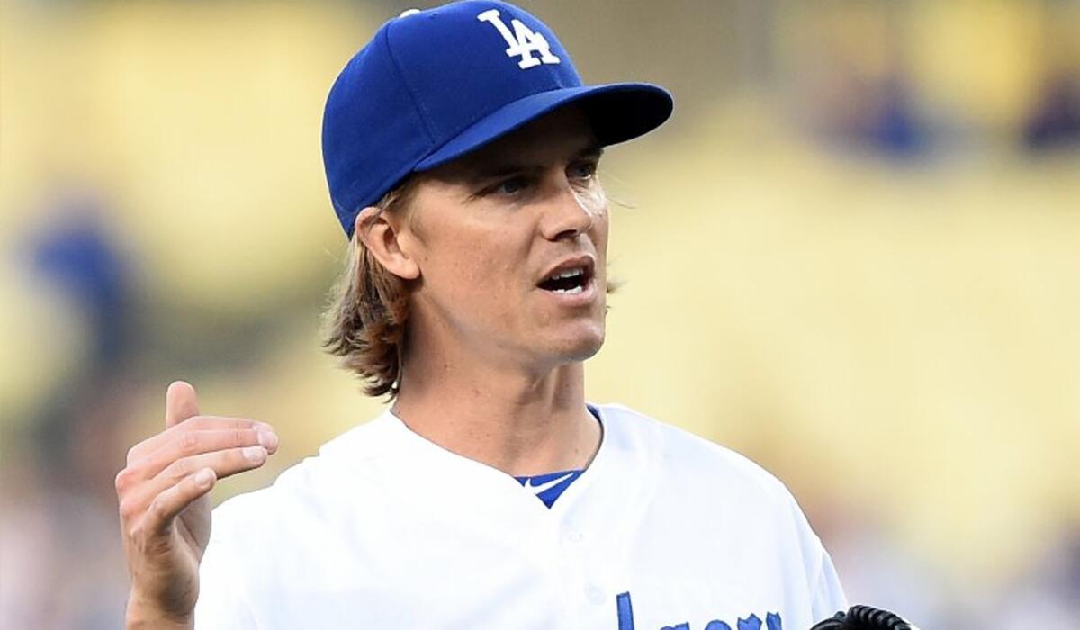 Dodgers starting pitcher Zack Greinke reacts to his walk to Nick Markakis that loaded the bases for the Braves in the first inning. Greinke escaped the jam unscathed.
