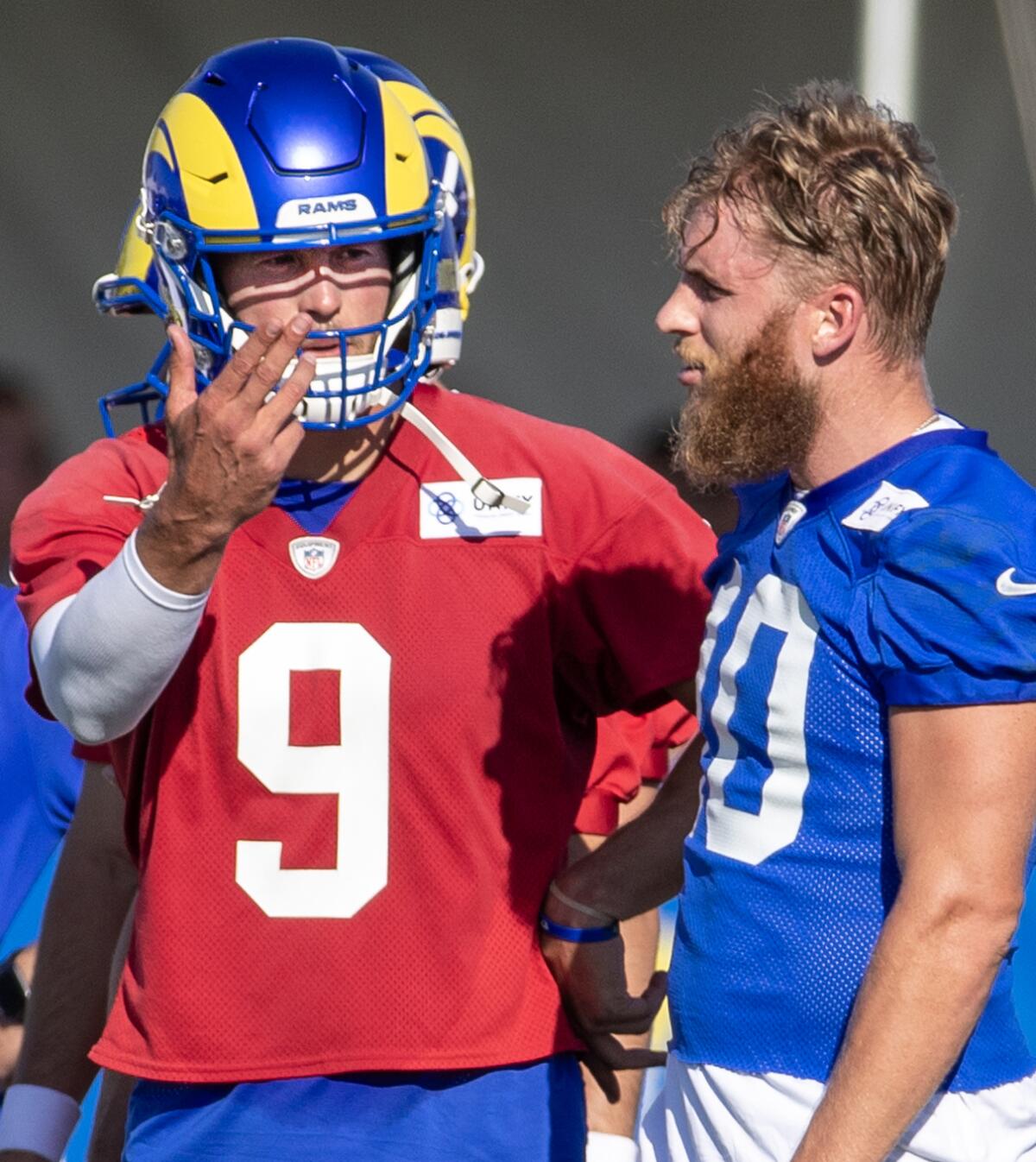 Rams quarterback Matthew Stafford (left) talks to receiver Cooper Kupp. 