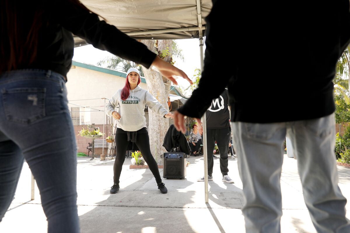 Choreographer Cynthia Garcia, center, instructs the quinceañera dancers.