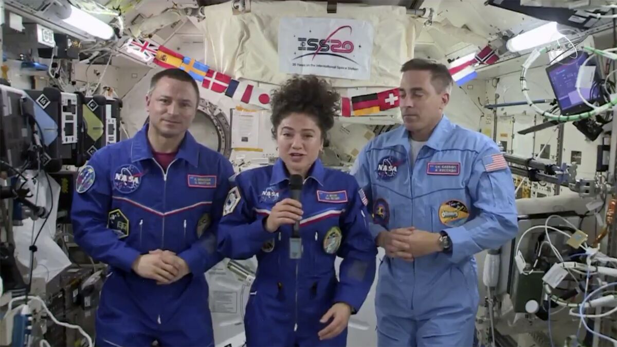U.S. astronaut Jessica Meir broadcasts from the space station with crewmates Andrew Morgan, left, and Chris Cassidy