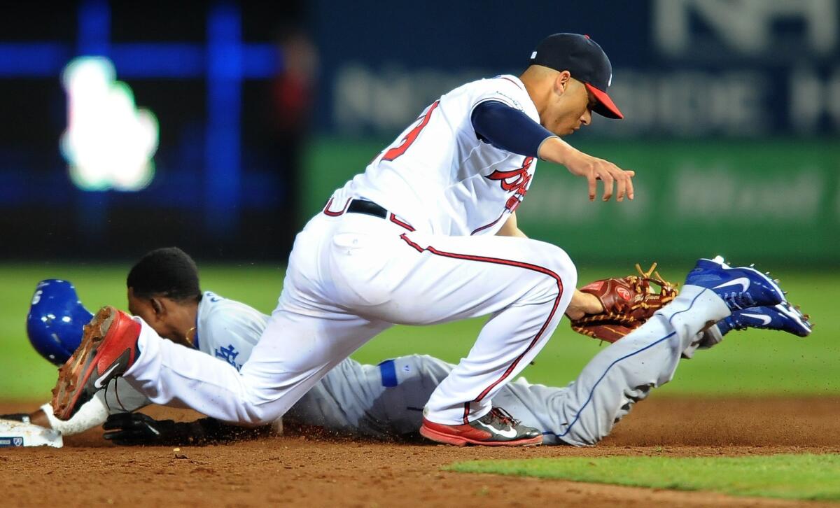 Dodgers pinch runner Dee Gordon is called out as he is tagged by Atlanta's Andrelton Simmons on a stolen base attempt during the Dodgers' 4-3 loss in Game 2 of the National League division series Friday.