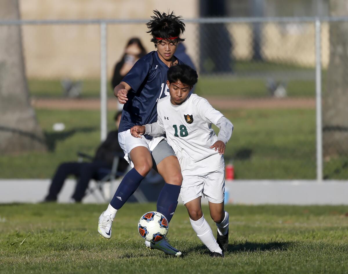 Waldorf's Brandon Wang Rancho Alamitos' battles Erick Anorve (18) in a CIF Division 7 wildcard game at Parsons Field.