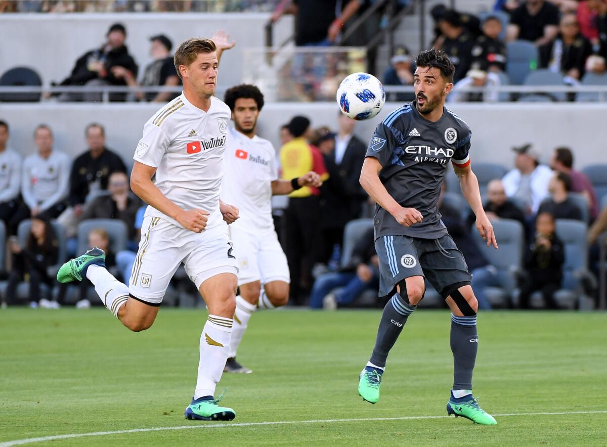 LOS ANGELES, CA - MAY 13: David Villa #7 of New York City takes a pass in front of Walker Zimmerman #25 of Los Angeles FC during the first half at Banc of California Stadium on May 13, 2018 in Los Angeles, California.
