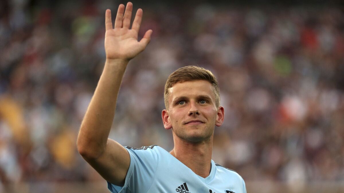 Minnesota United midfielder Collin Martin, who came out publicly as gay earlier in the day, waves to fans after taking part in a halftime presentation during the team's match against FC Dallas on June 29.