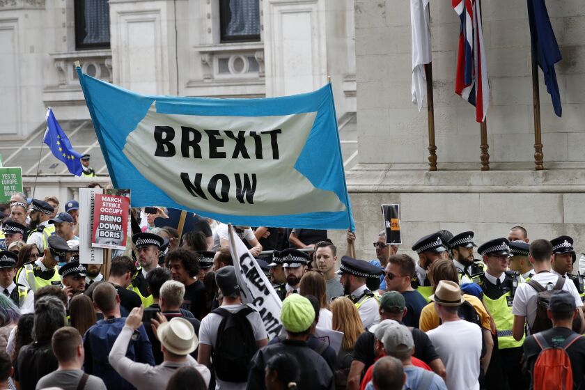 Brexit supporters gather during a rally in London, Saturday, Aug. 31, 2019. Political opposition to Prime Minister Boris Johnson's move to suspend Parliament is crystalizing, with protests around Britain and a petition to block the move gaining more than one million signatures. (AP Photo/Alastair Grant)