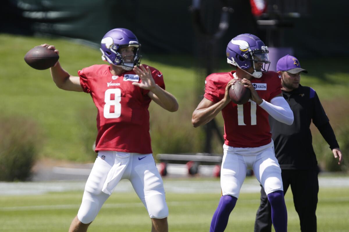 Minnesota Vikings quarterback Kirk Cousins (8) and Vikings quarterback Kellen Mond prepare to throw at the NFL football team's practice facility in Eagan, Minn., Monday, Aug. 1, 2022. (AP Photo/Andy Clayton-King)