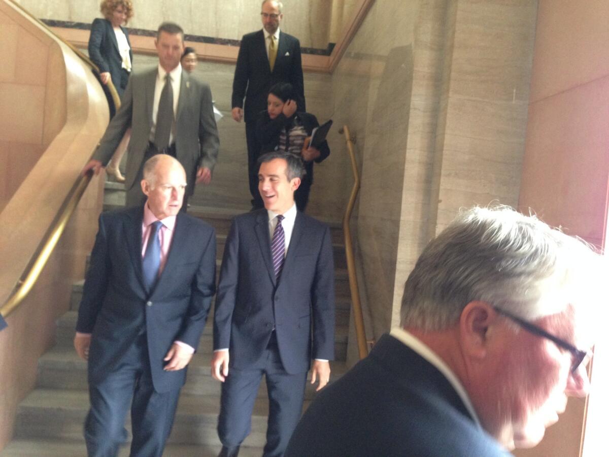 Los Angeles Mayor Eric Garcetti speaks with Gov. Jerry Brown Thursday at City Hall.