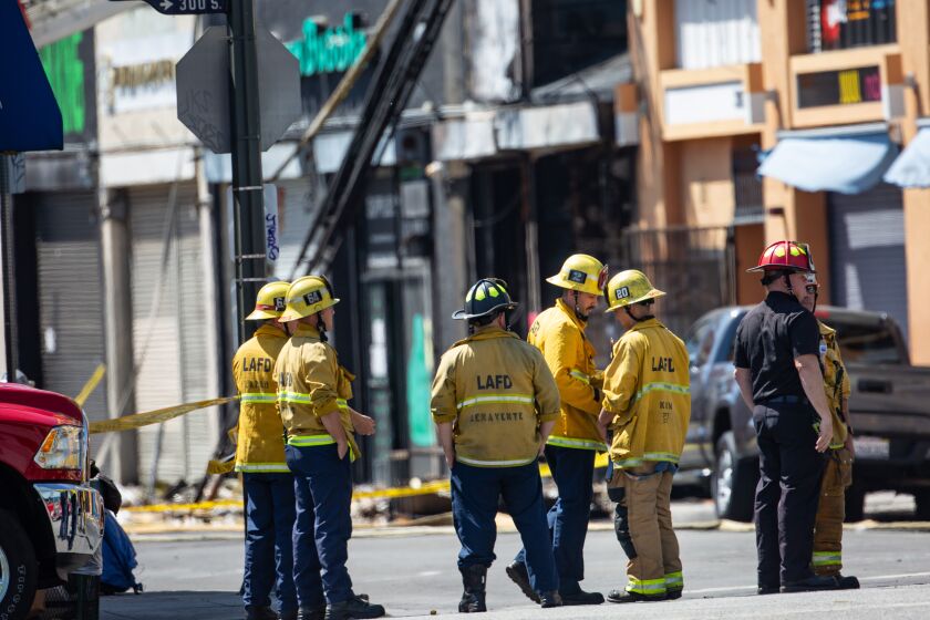 LOS ANGELES, CA - MAY 17: Firefighters and other officials investigate a downtown scene were an explosion and fire injured 11 fire fighters yesterday in Little Tokyo during the coronavirus pandemic on Sunday, May 17, 2020 in Los Angeles, CA. (Jason Armond / Los Angeles Times)